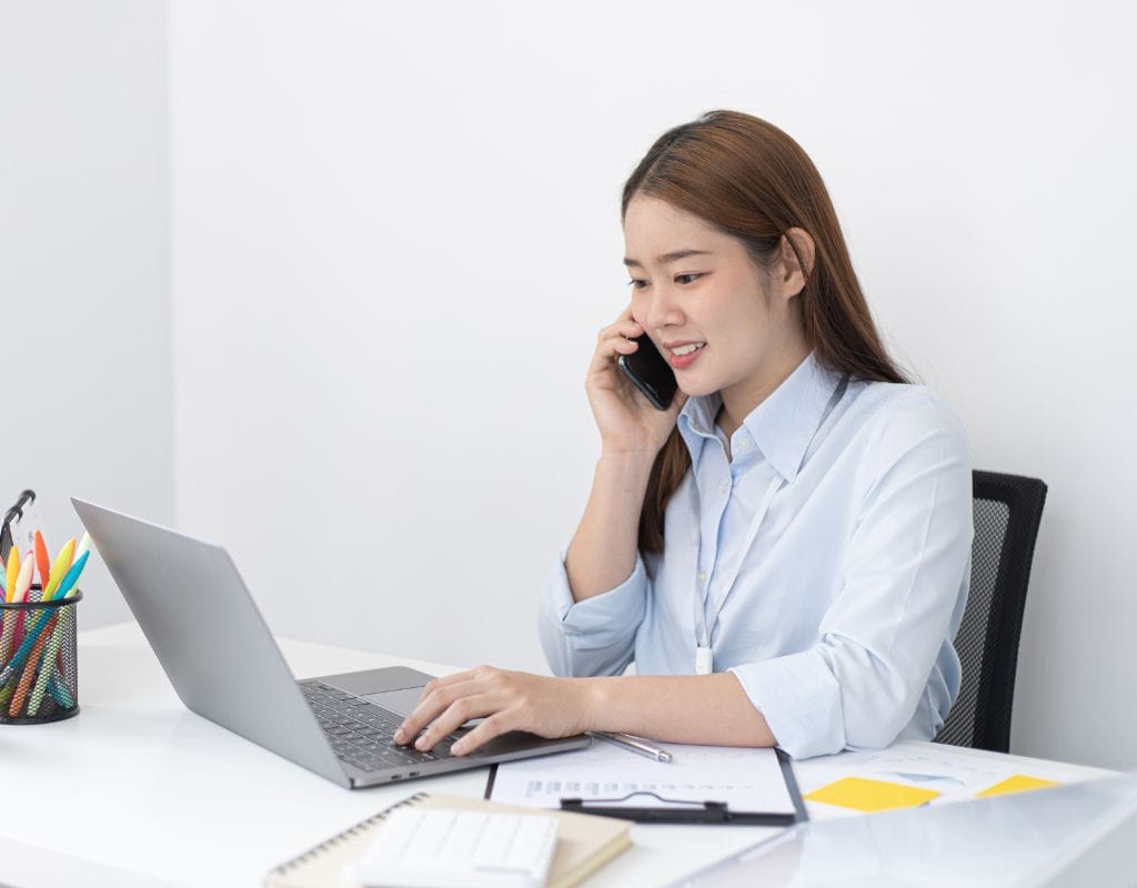 Woman Working at the Office in a Phone Call