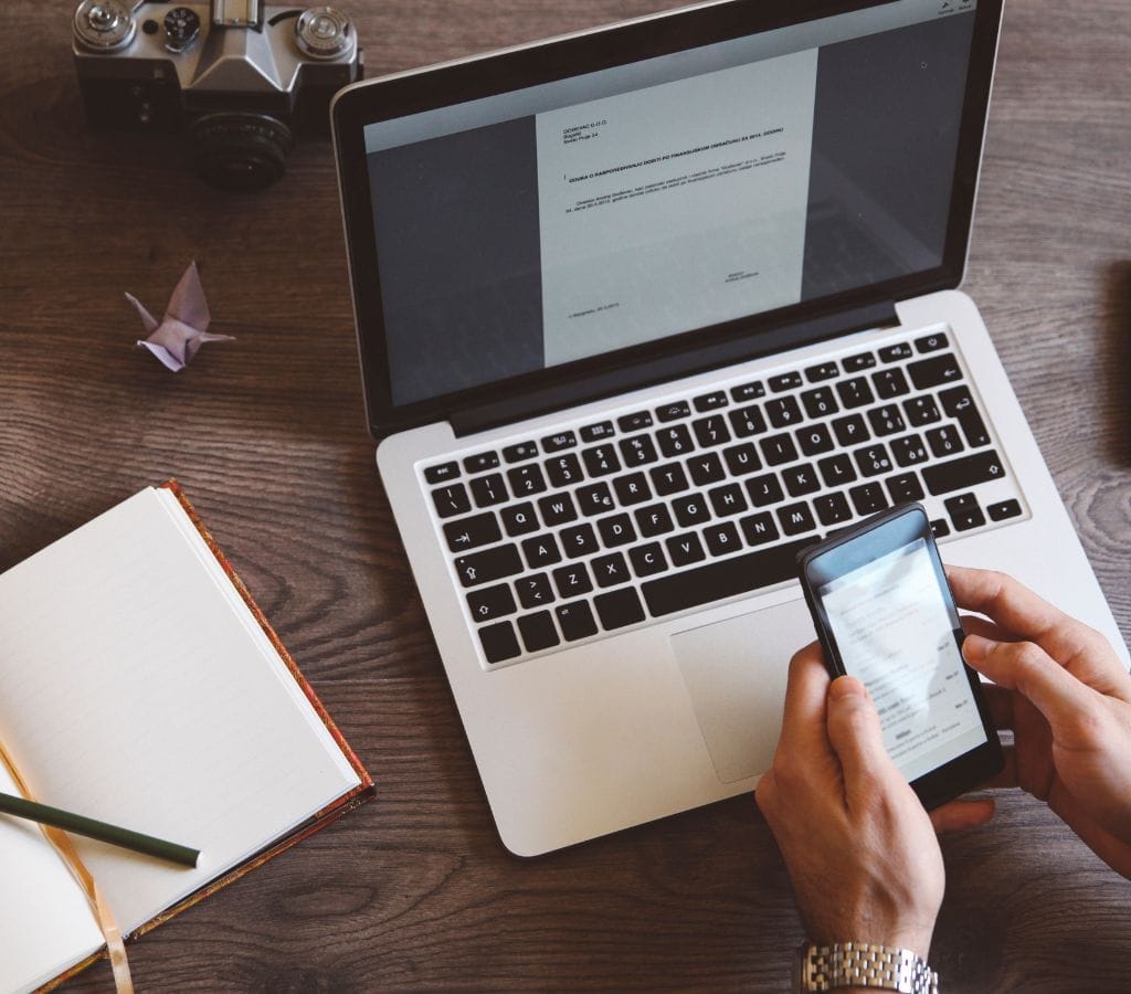 man working from home checking emails on the smartphone