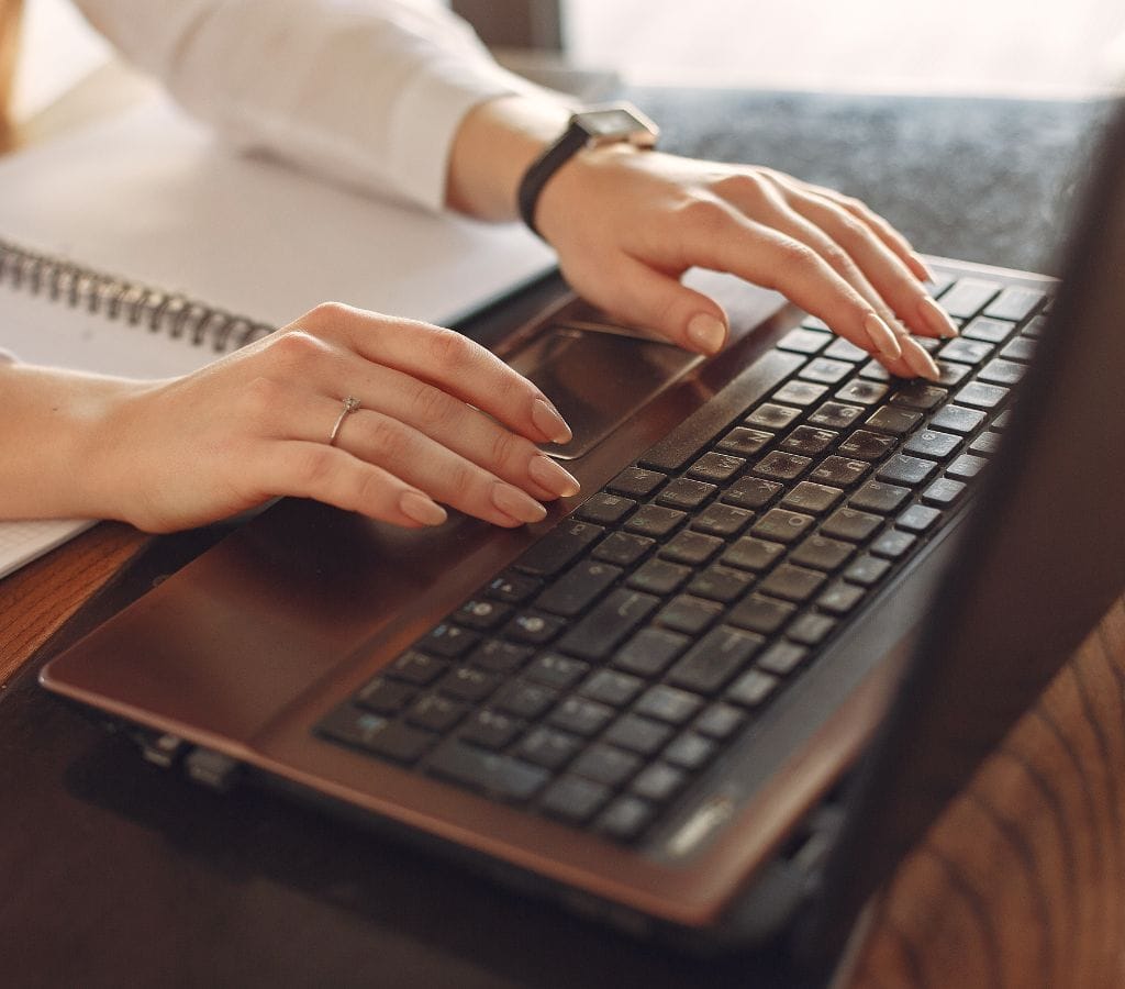 a woman writing an email reply on a laptop