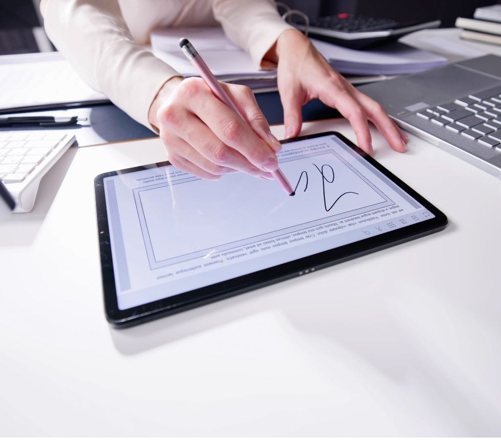 a woman creating a signature on iPad with stylus pen