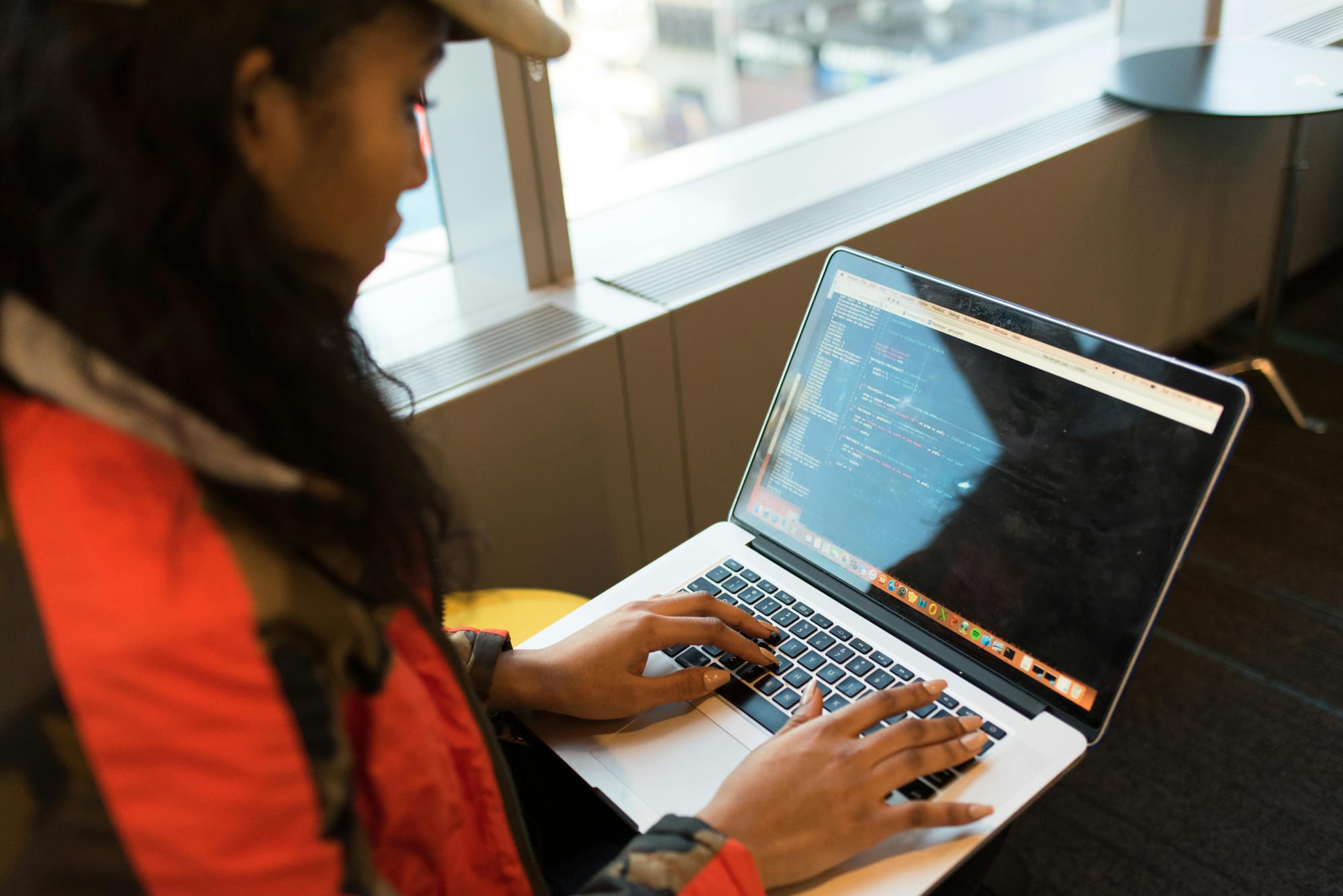 a woman typing html code working from anywhere