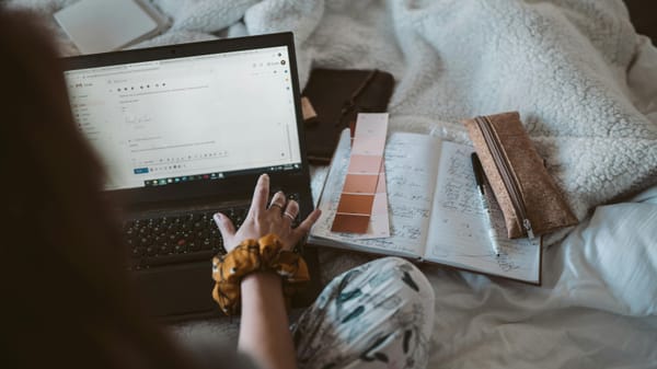 a woman working from home and replying to an email